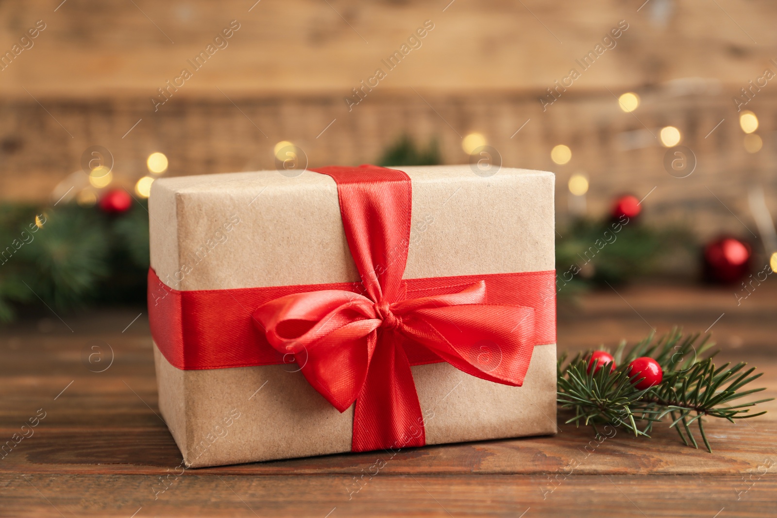 Photo of Christmas gift and fir tree branches on wooden table. Boxing day