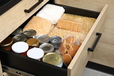 Photo of Open drawer with different products. Food donation