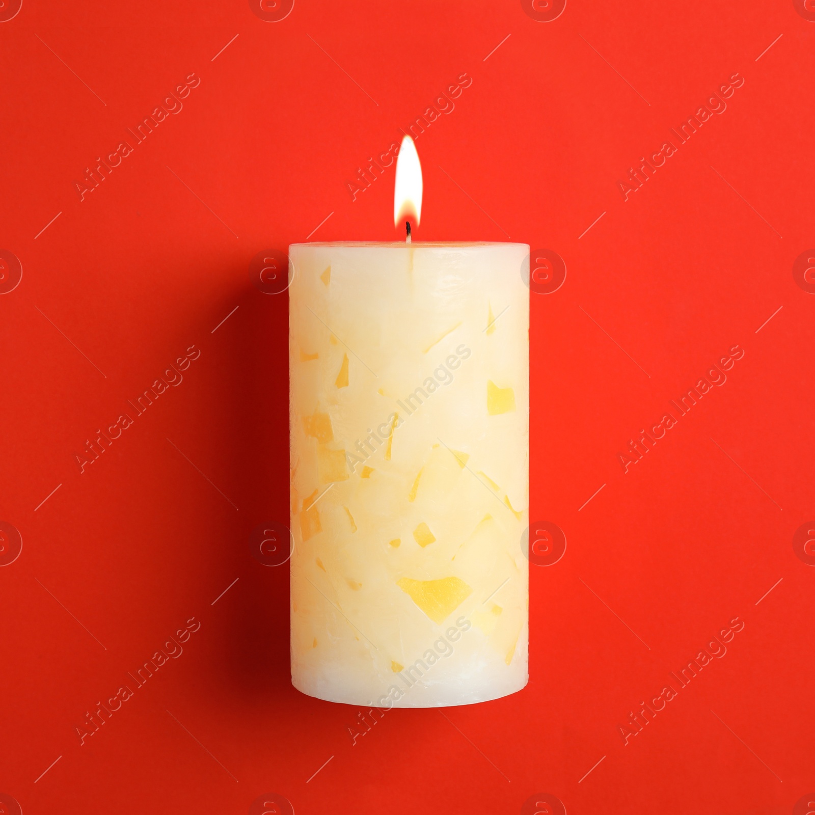 Photo of Alight scented wax candle on color background