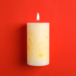 Photo of Alight scented wax candle on color background