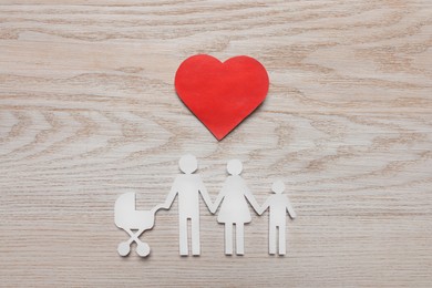 Paper family cutout and red heart on white wooden background, flat lay. Insurance concept