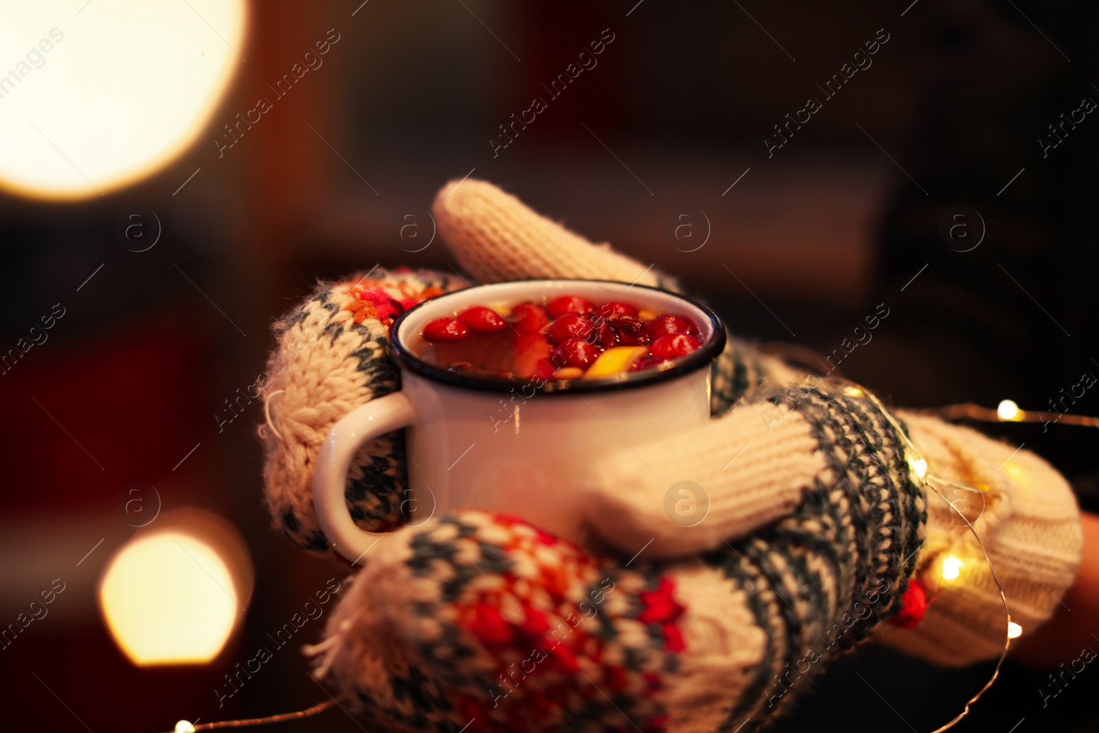 Photo of Woman with mulled wine at winter fair, closeup