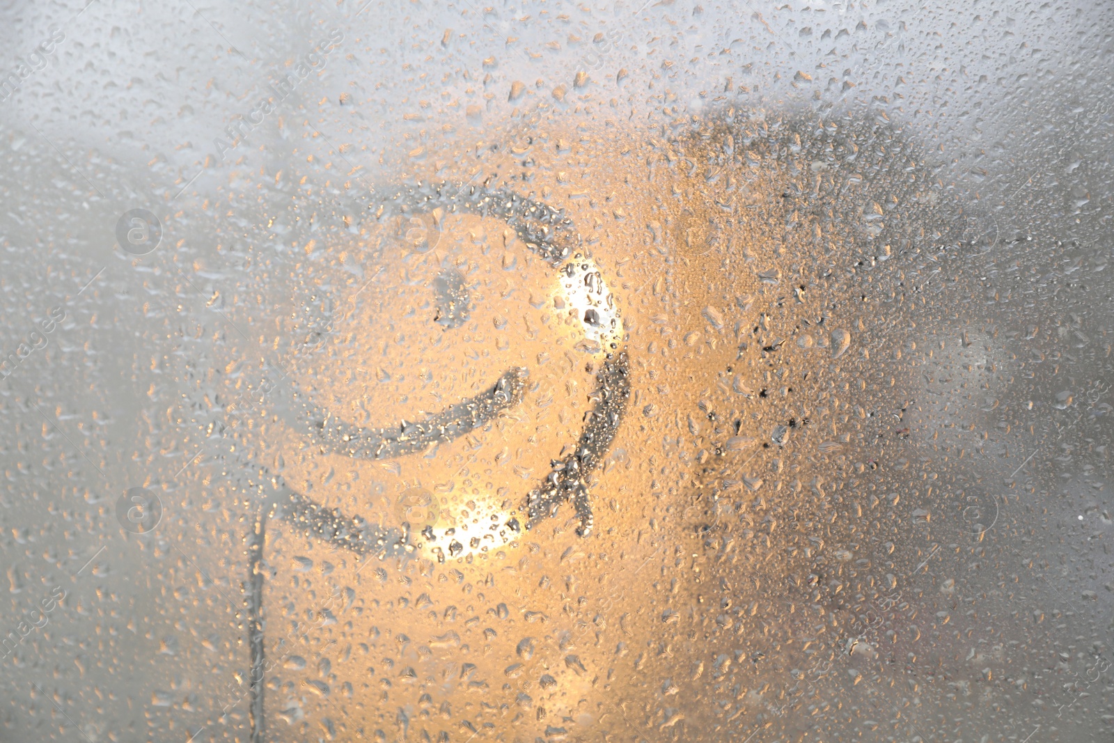 Photo of Happy face drawn on foggy window, space for text. Rainy weather