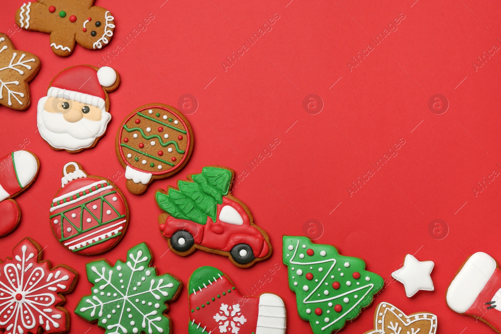 Photo of Different tasty Christmas cookies on red background, flat lay. Space for text