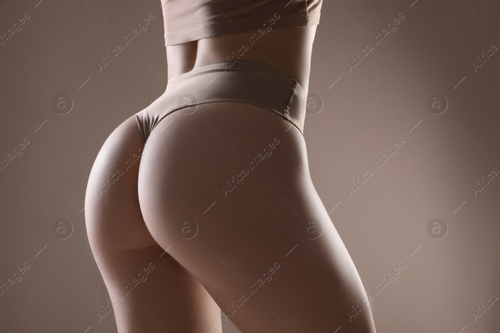 Photo of Closeup view of slim woman in underwear on beige background. Cellulite problem concept
