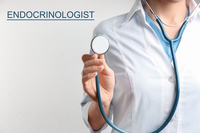 Endocrinologist with stethoscope on light grey background, closeup