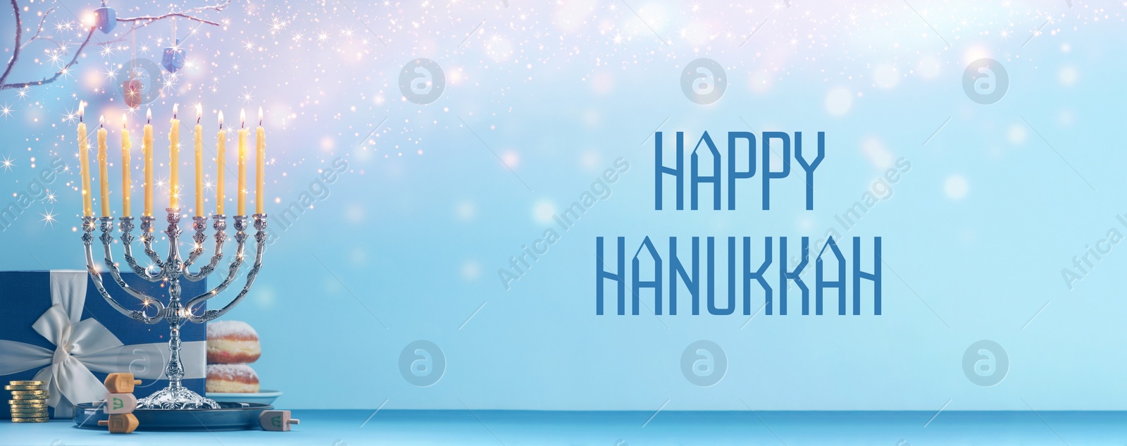 Image of Happy Hanukkah. Menorah, donuts, dreidels and gift on blue table, banner design