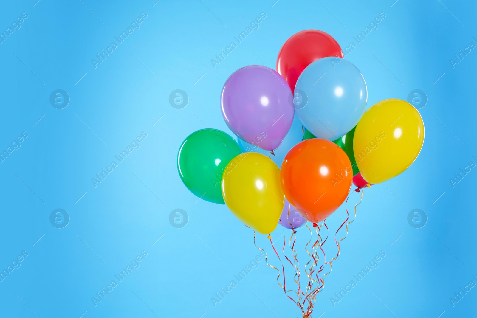 Photo of Bunch of bright balloons on color background. Space for text