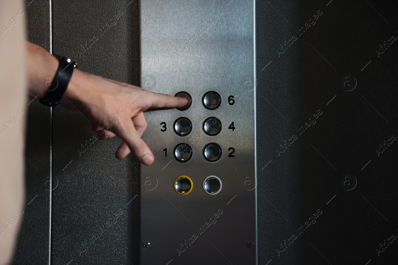 Photo of Man choosing floor in elevator, closeup view