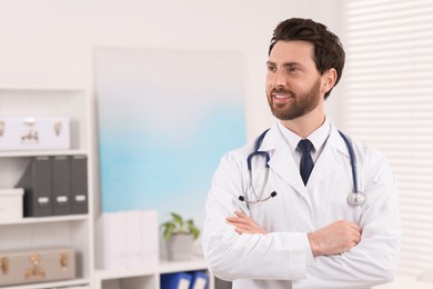 Medical consultant with stethoscope in clinic, space for text