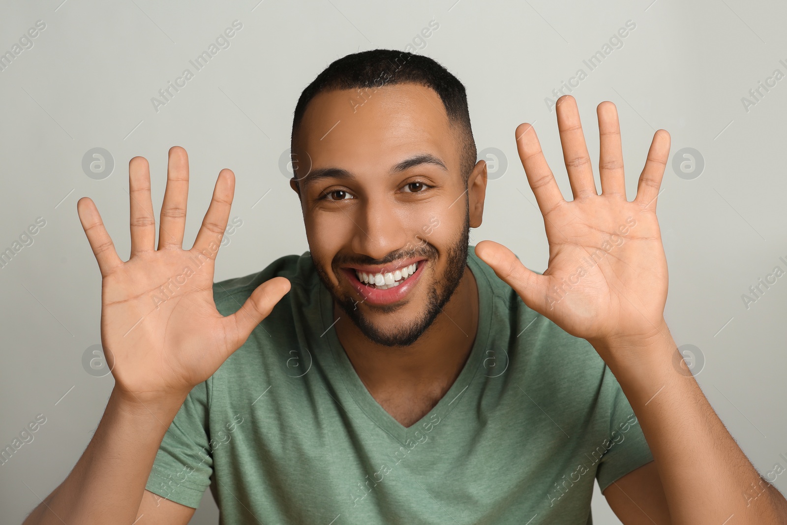 Photo of Happy man stuck to transparent screen. Internet addiction concept