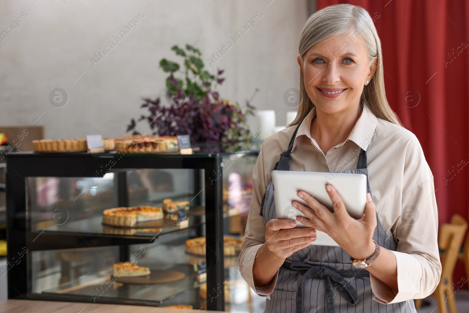 Photo of Happy business owner with tablet in her cafe, space for text