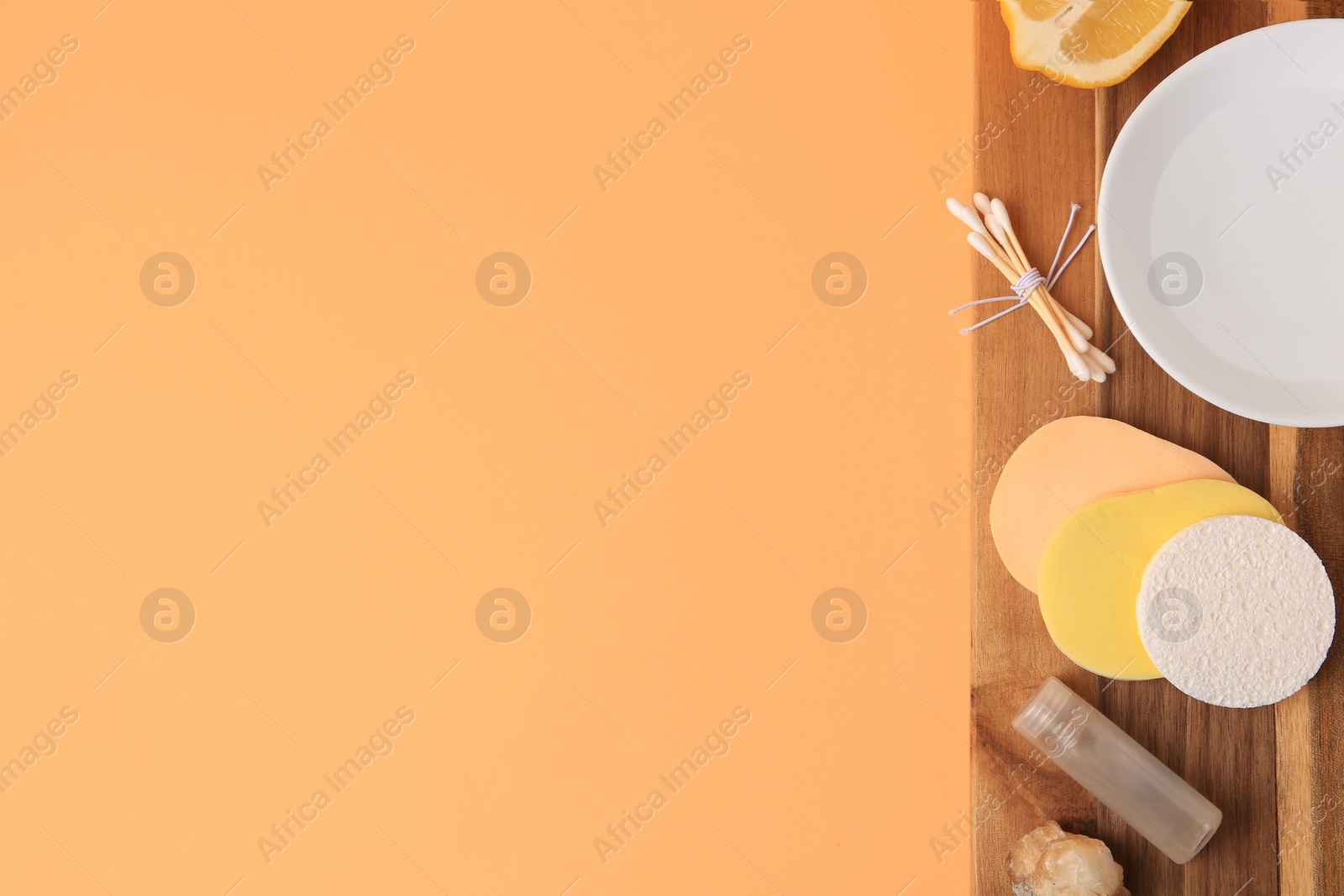 Photo of Lemon face cleanser. Fresh citrus fruits and personal care products on pale orange background, top view with space for text