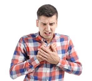 Young man suffering from chest pain on white background