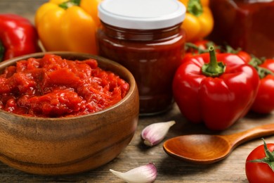 Photo of Delicious lecho and fresh ingredients on wooden table, closeup