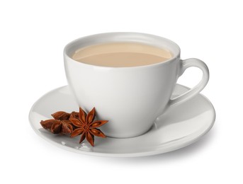 Cup of tea with milk and anise stars on white background