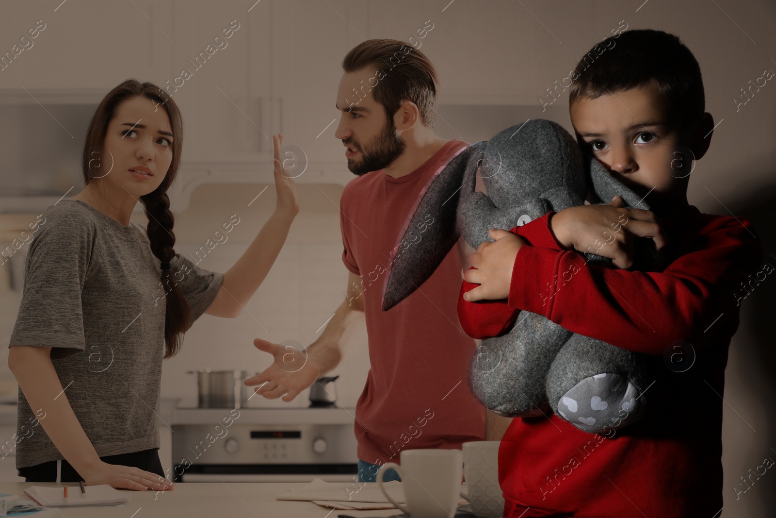 Image of Double exposure of sad little boy with toy and his arguing parents
