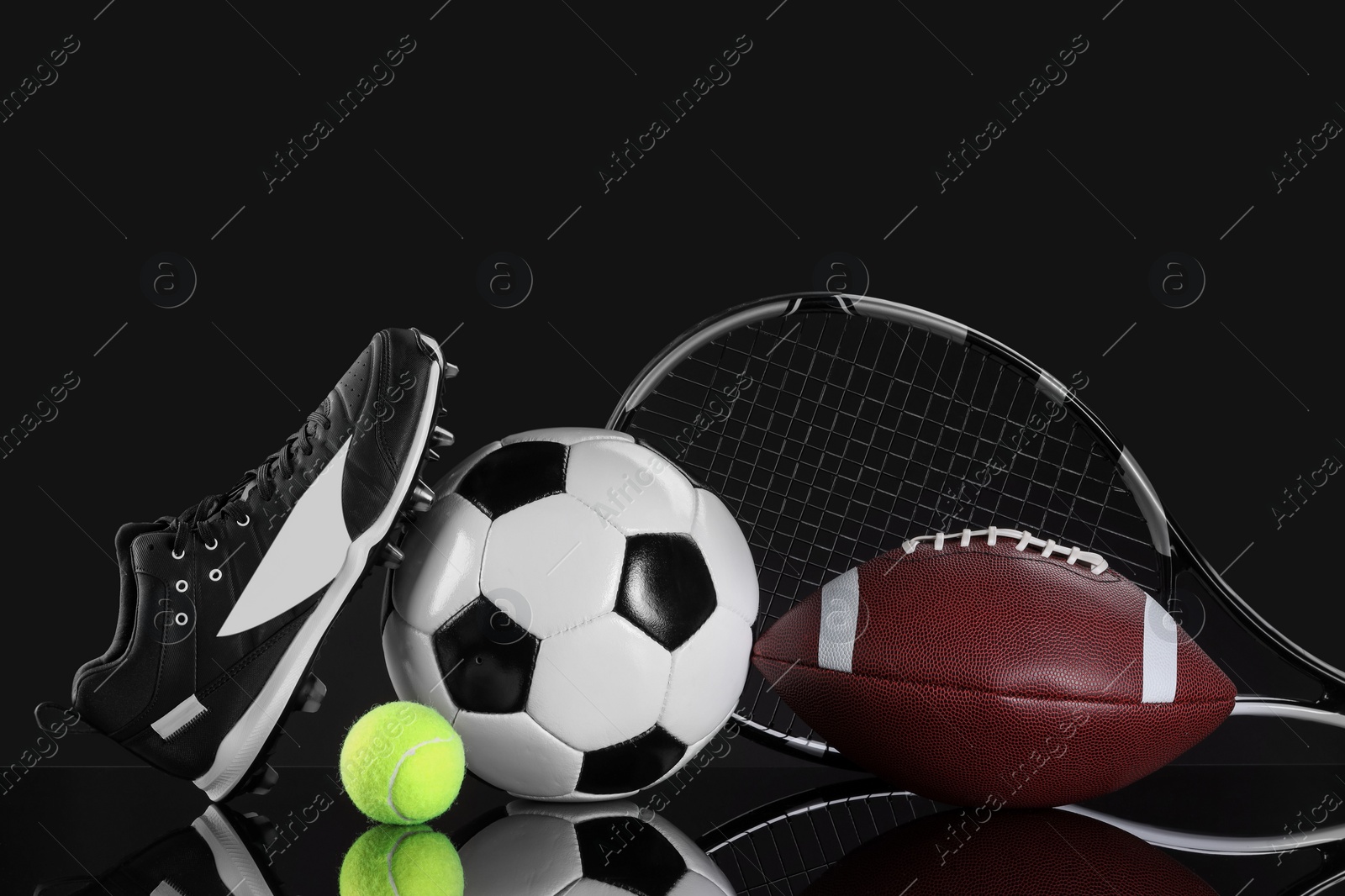 Photo of Many different sports equipment on black mirror surface