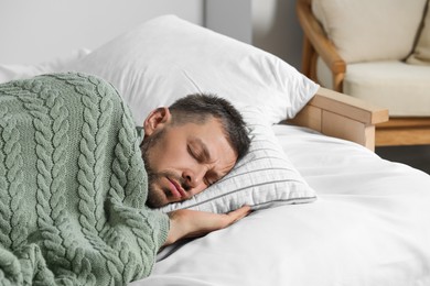 Photo of Tired man sleeping in bed at home