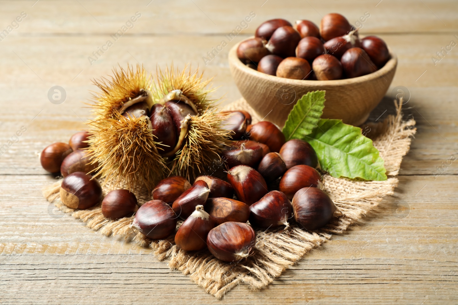 Photo of Fresh sweet edible chestnuts on wooden table