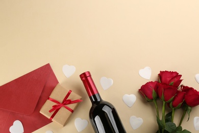 Photo of Flat lay composition with gift box and roses on beige background, space for text. Valentine's day celebration