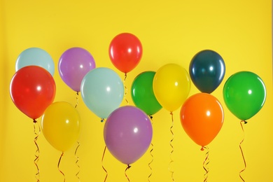 Photo of Bright balloons on color background. Celebration time