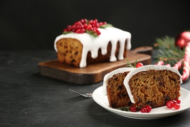 Traditional Christmas cake on black table, space for text. Classic recipe