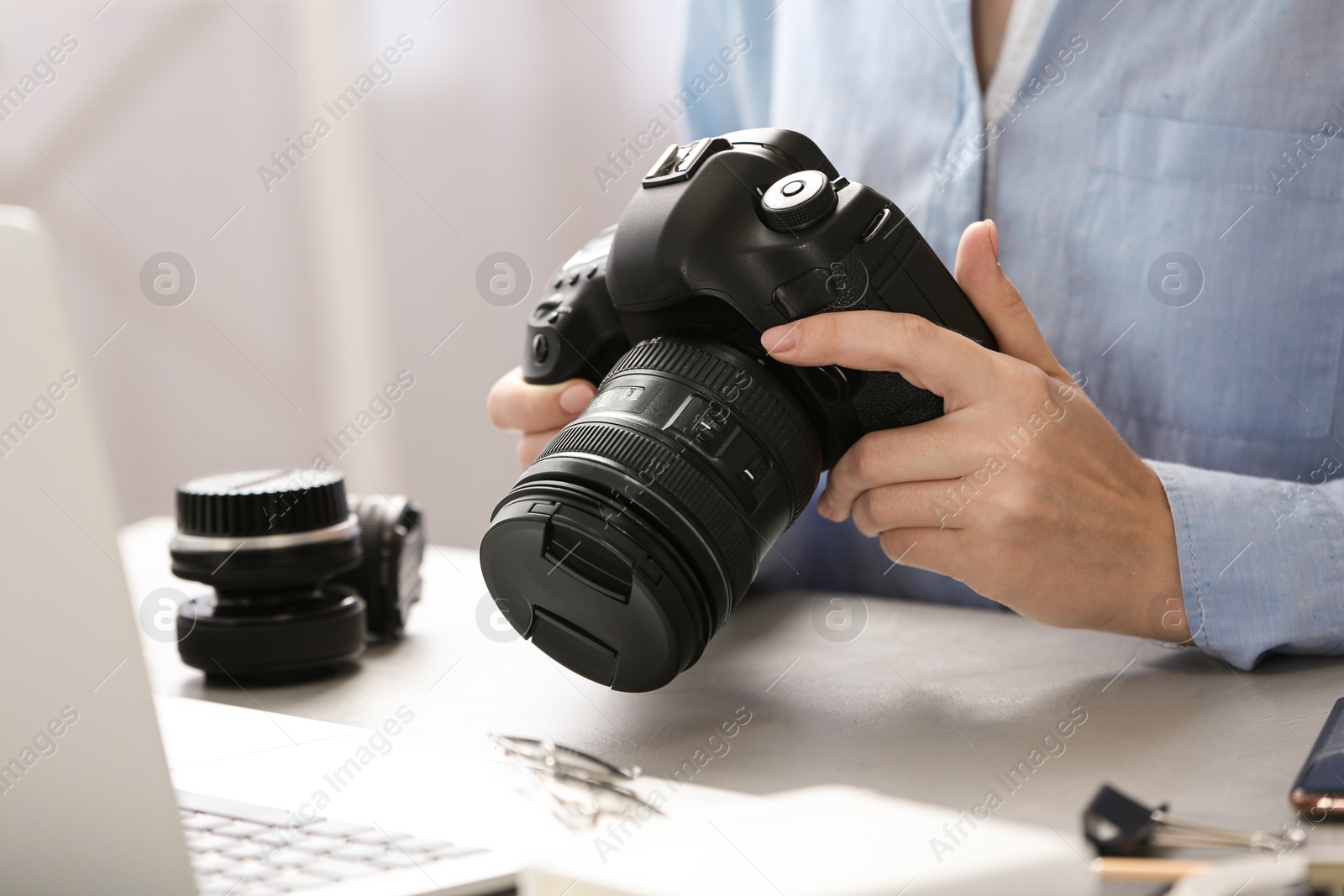 Photo of Journalist with camera working at table, closeup