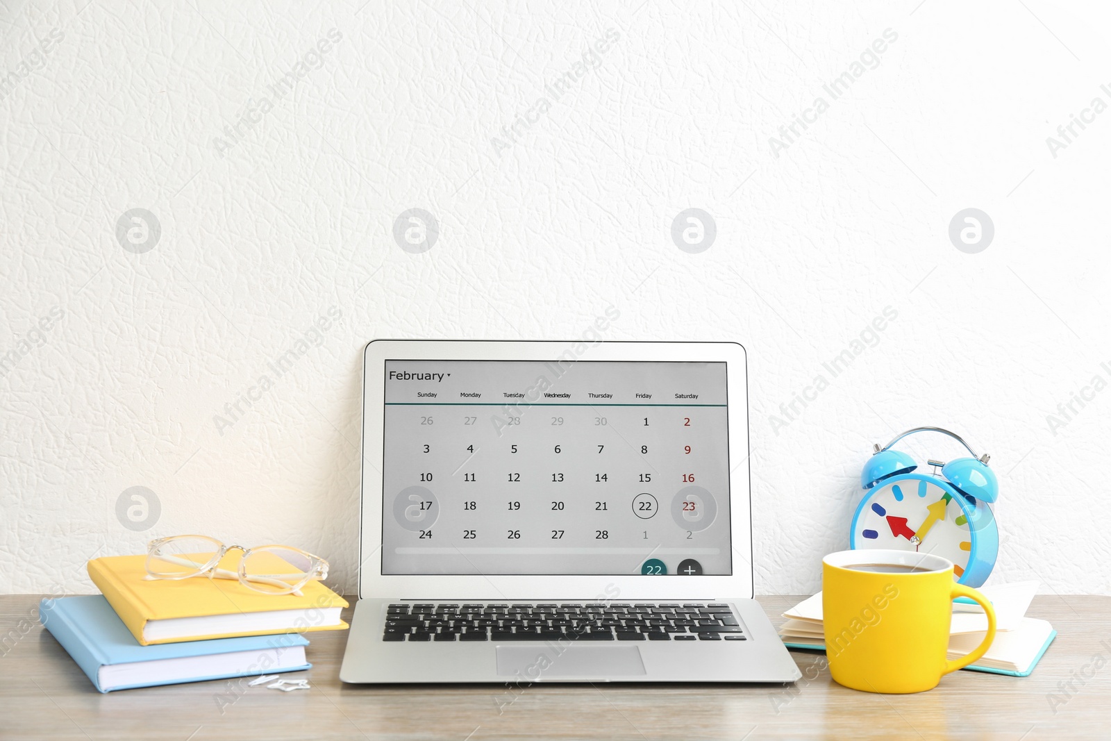 Photo of Modern laptop with calendar app in office
