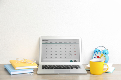 Modern laptop with calendar app in office