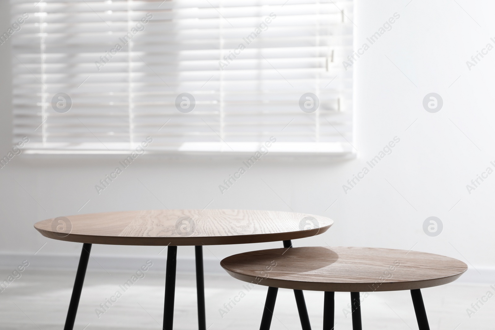 Photo of Empty wooden nesting tables indoors. Stylish furniture