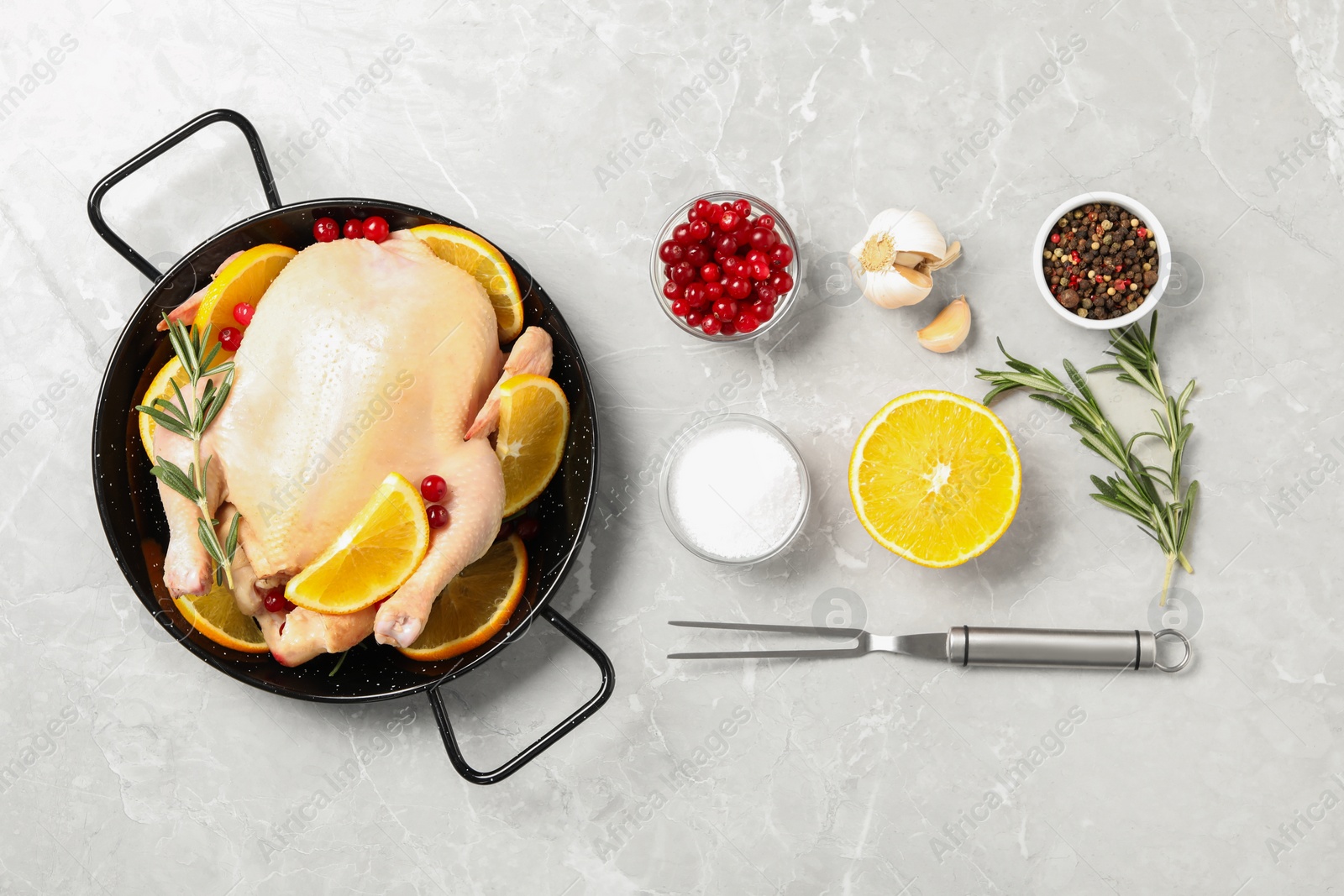 Photo of Flat lay composition with chicken, orange slices and other ingredients on light grey marble table