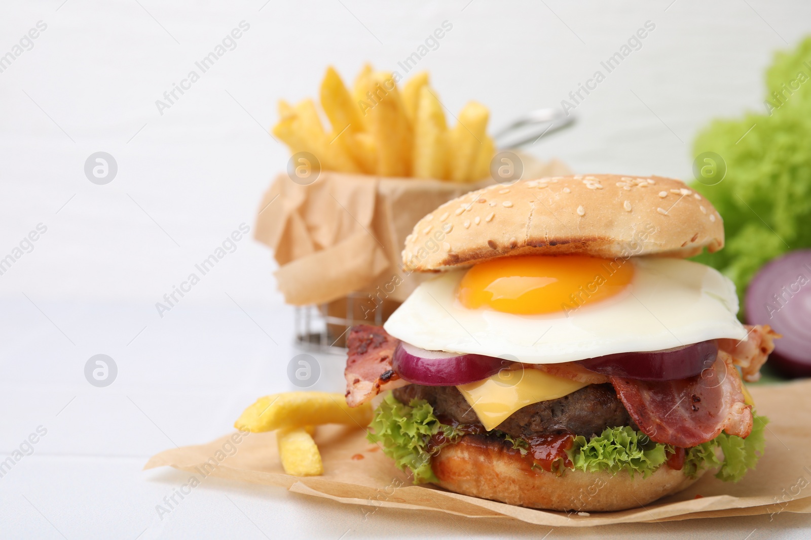 Photo of Delicious burger with fried egg on white table, closeup. Space for text