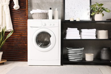 Stylish laundry room with modern washing machine. Interior design