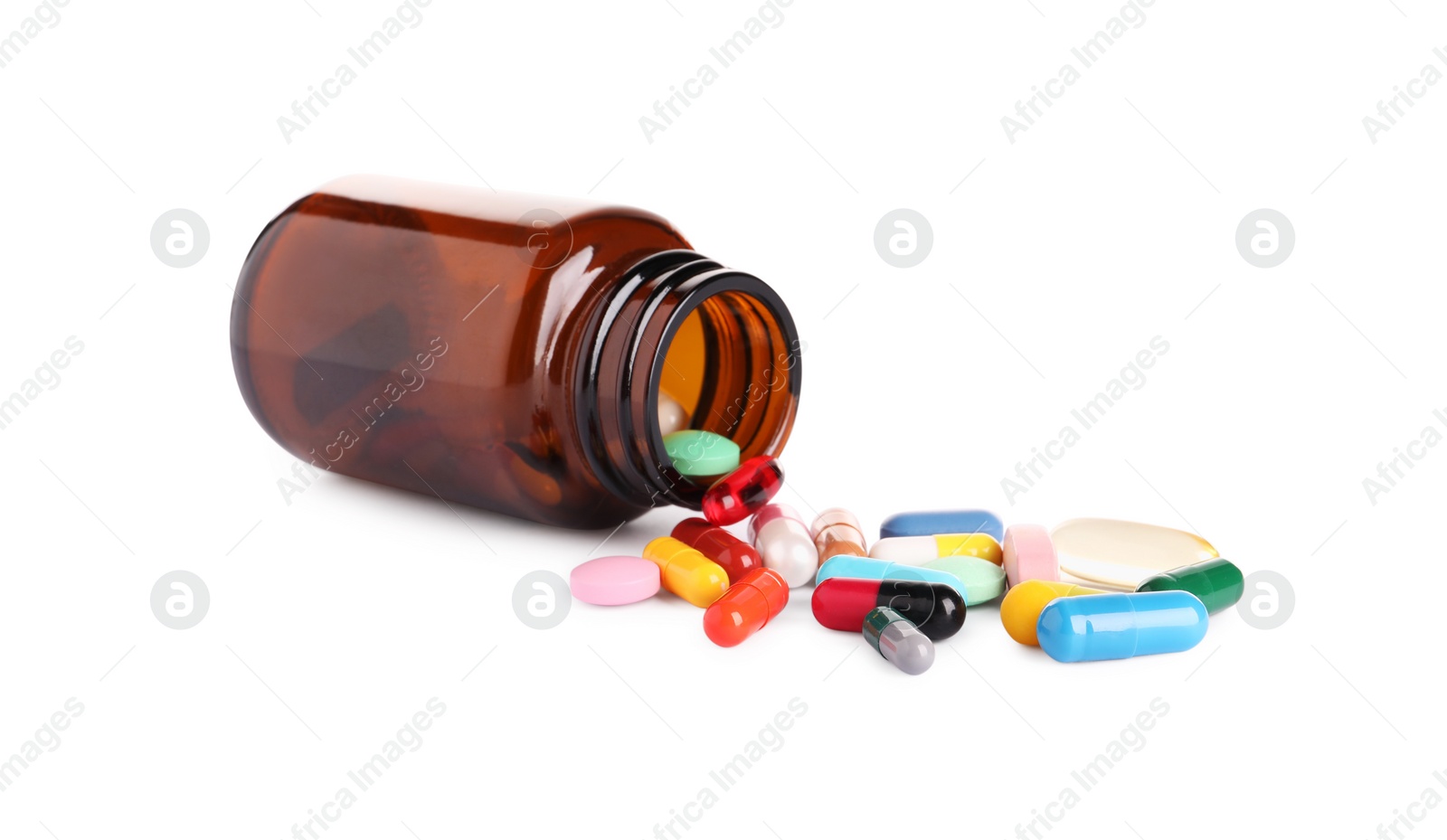 Photo of Plastic medical bottle with many different pills isolated on white