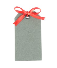 Photo of Blank grey gift tag with red satin ribbon on white background, top view. Space for design