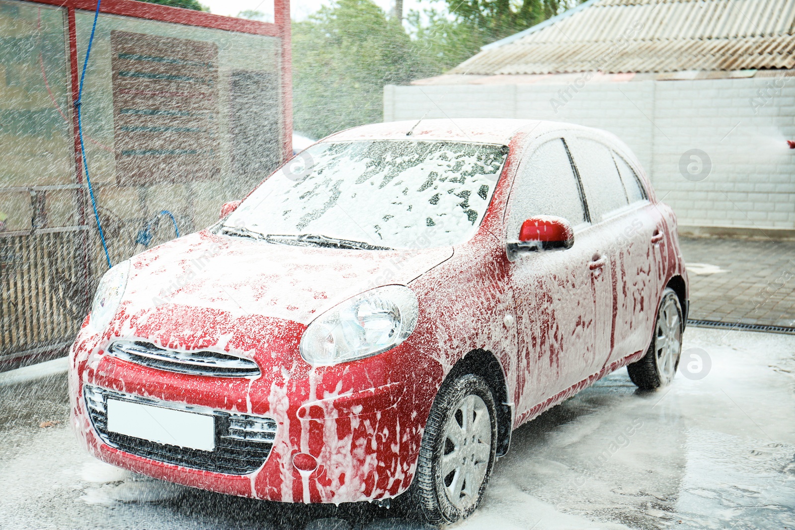 Photo of Cleaning vehicle with high pressure foam jet at car wash