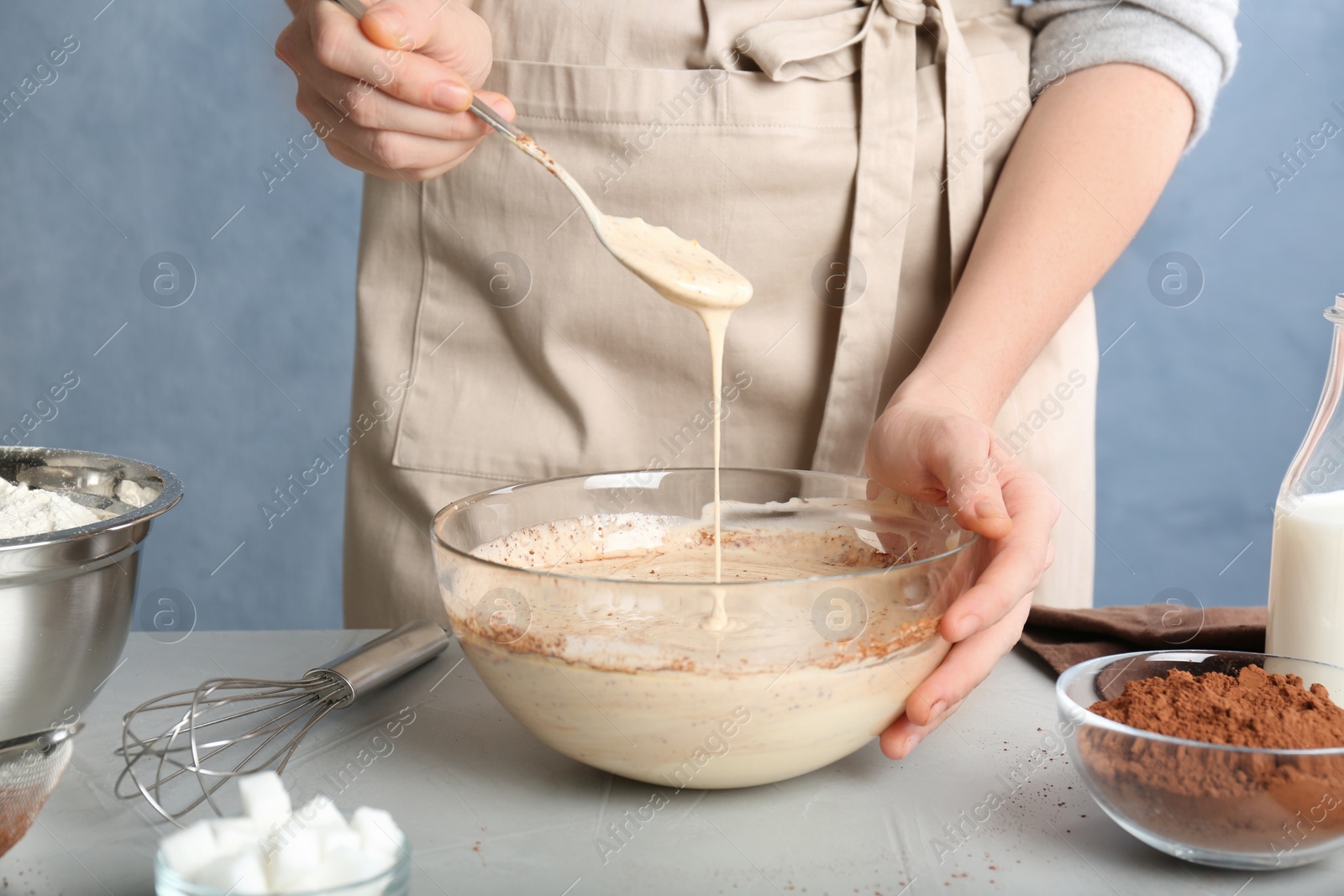 Photo of Woman making batter at light table, closeup