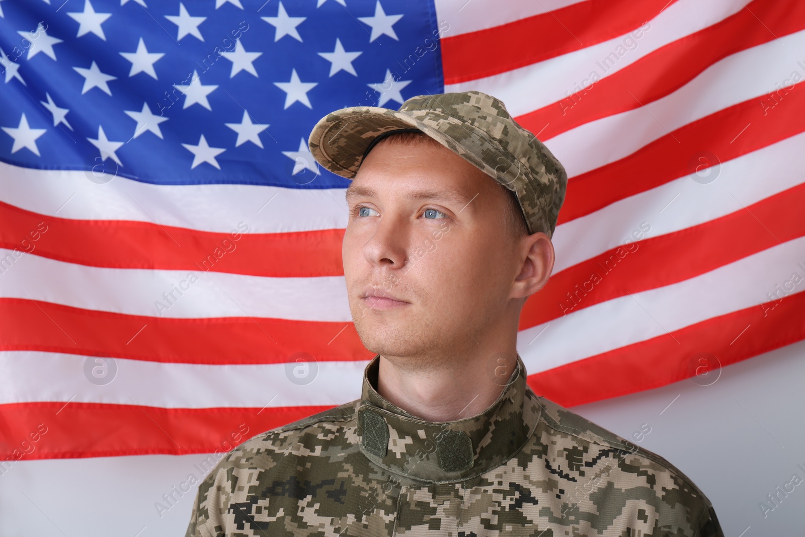 Photo of Soldier in uniform and United states of America flag on white background