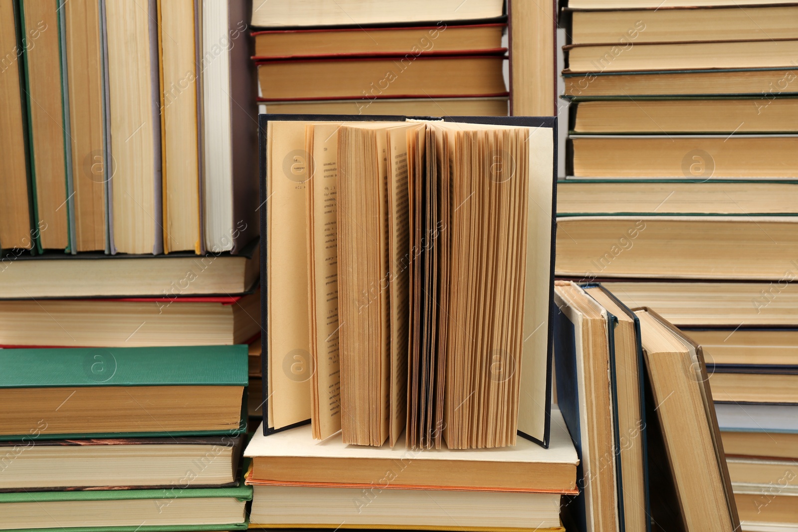 Photo of Many hardcover books as background. Library material