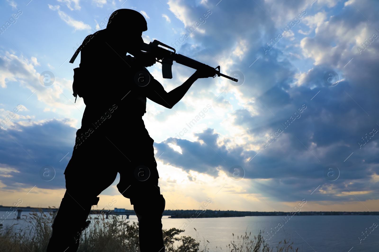 Photo of Soldier with machine gun patrolling outdoors. Military service