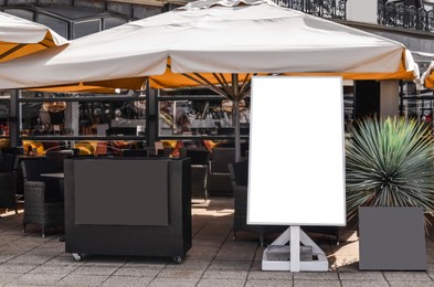 Photo of Beautiful straw beach umbrellas in modern outdoors cafe