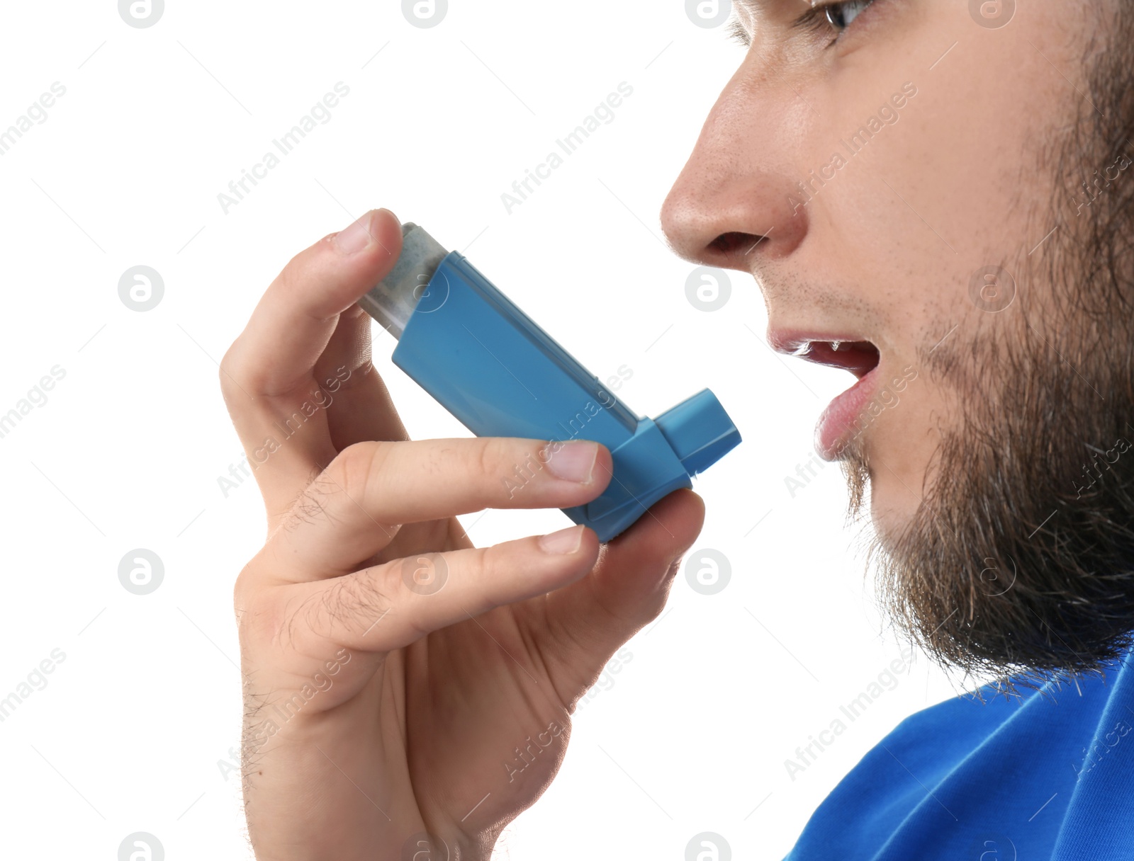 Photo of Young man using asthma inhaler on white background, closeup