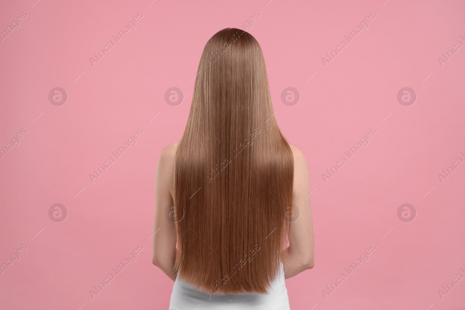 Photo of Woman with healthy hair on pink background, back view