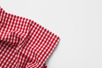 Photo of Red checkered tablecloth on white background, top view
