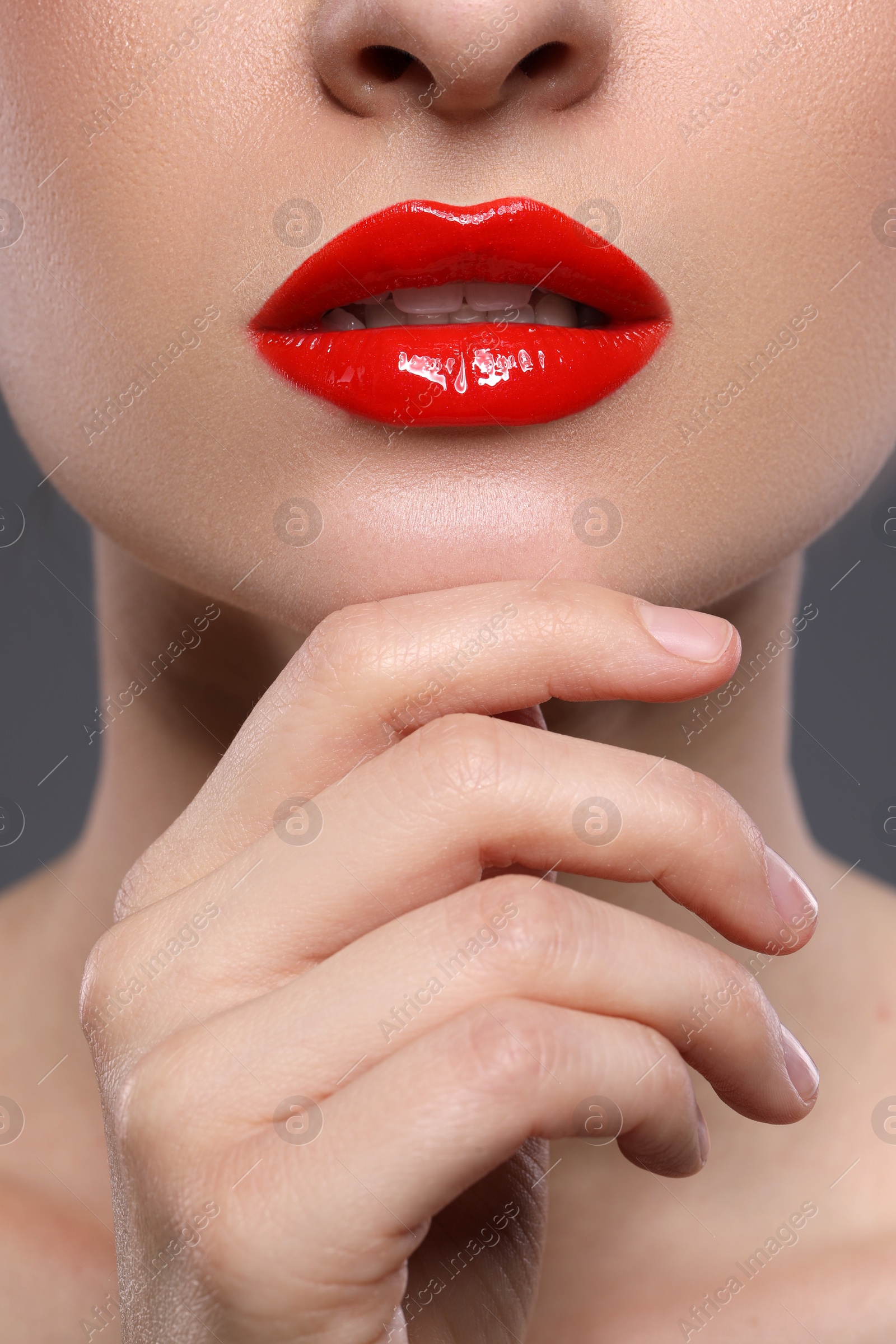 Photo of Young woman with beautiful red lips, closeup