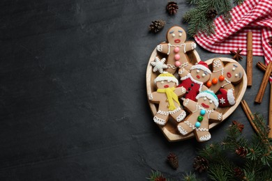 Flat lay composition with delicious Christmas cookies on black table, space for text