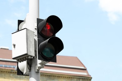 Post with traffic light for pedestrians in city