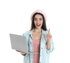 Portrait of young woman in casual outfit with laptop on white background