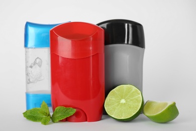 Photo of Different natural male deodorants,lime and mint on white background